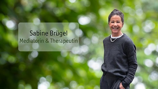 Sabine Brügel Frau mit dunklem Pullover und kurzer Frisur lächelnd vor unscharf grünem Hintergrund mit Textfeld 'Sabine Brügel Mediatorin & Therapeutin'.
